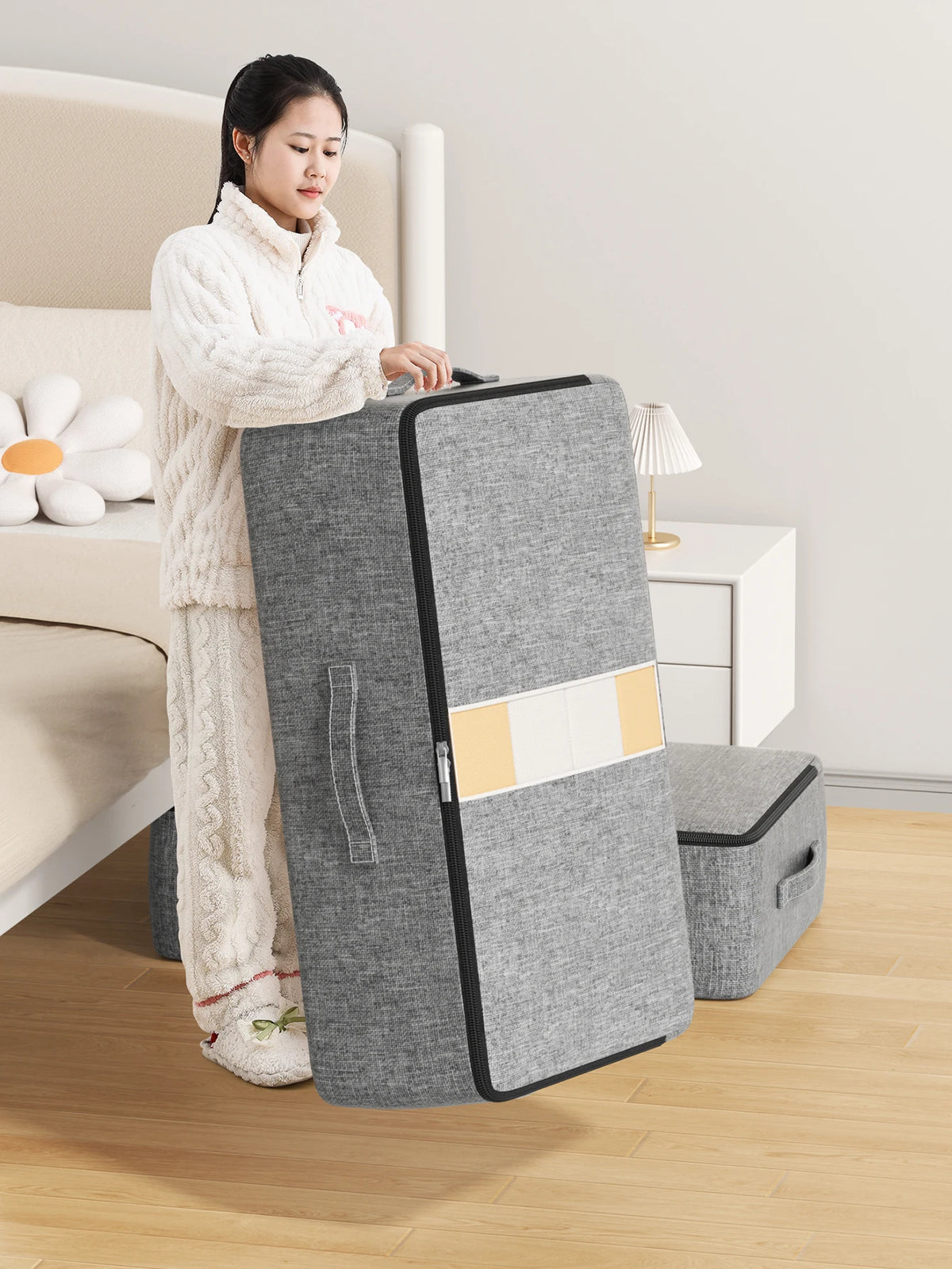 Under-bed storage bag standing on its end next to a bed