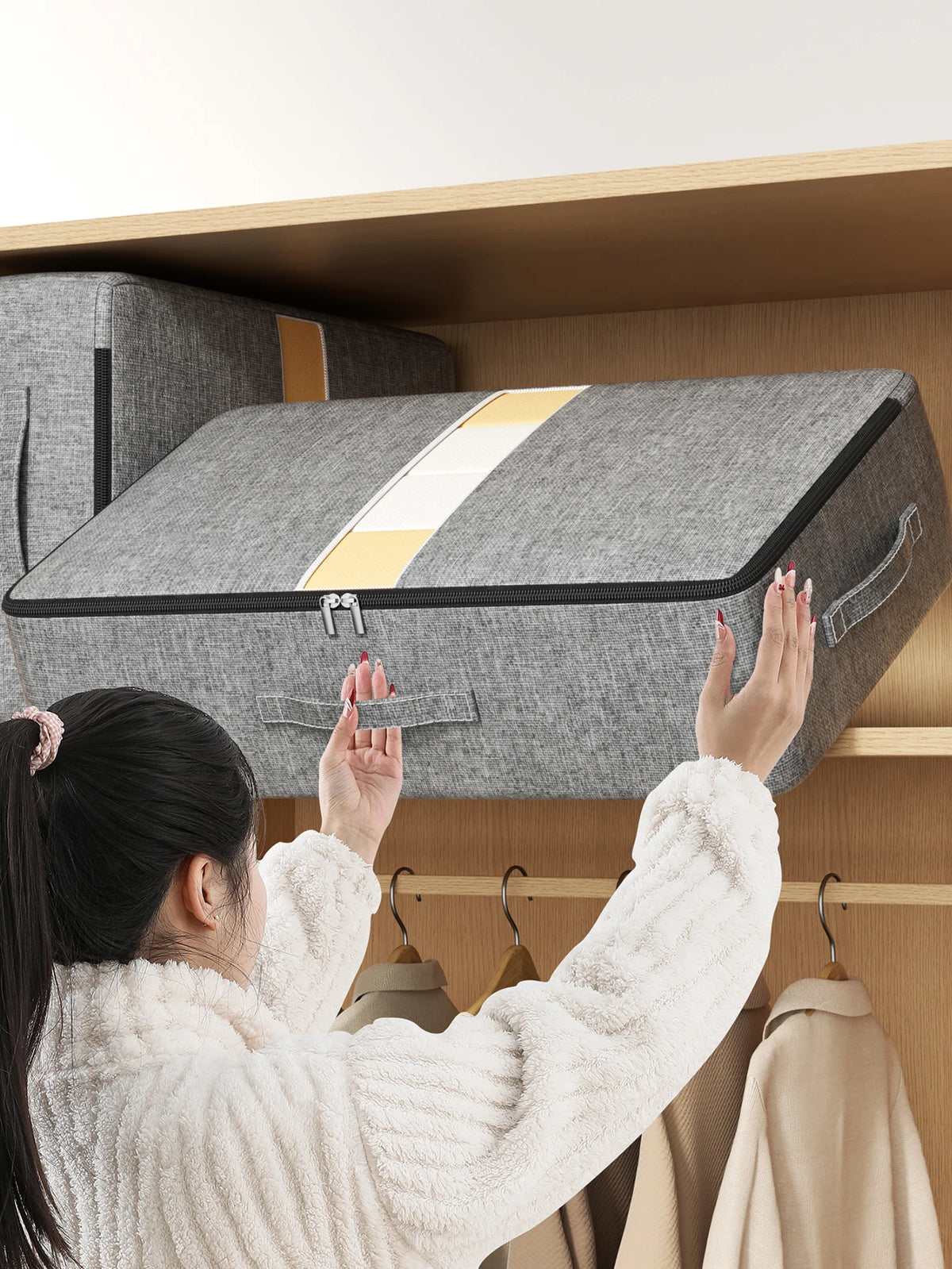 Under-bed storage bag lifted onto a wardrobe shelf