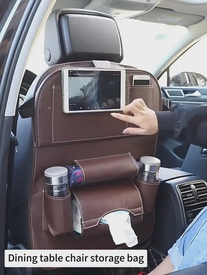 Car seat back organiser in use: tablet holder, fold-down tray and pockets
